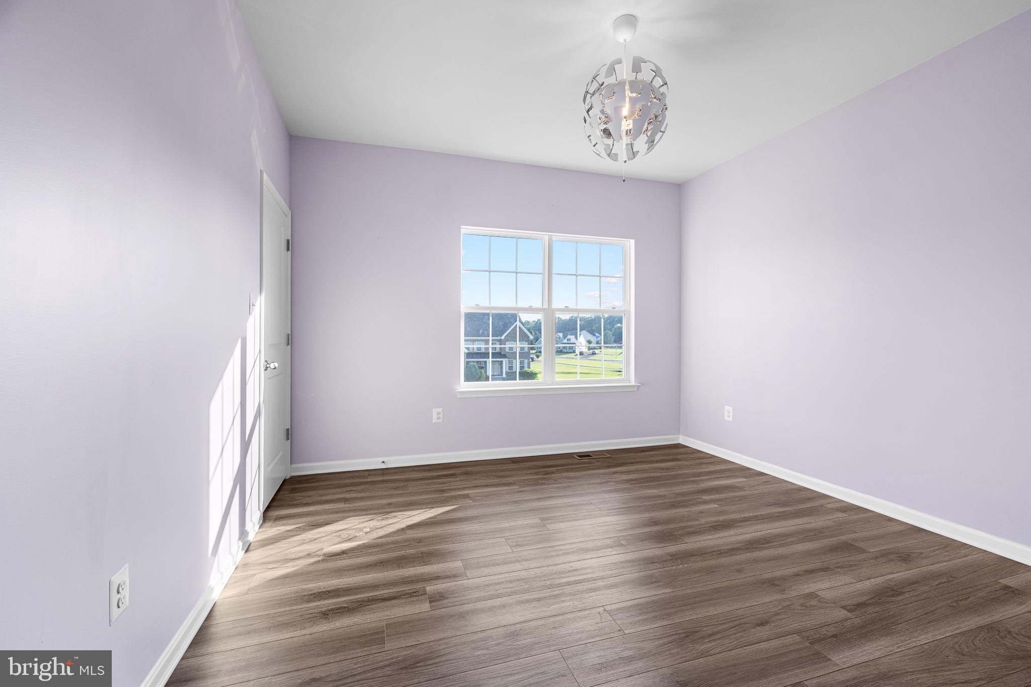 1022 Fawn Haven Walk Dover, DE 19901 - Photo 27 of 46 an empty room with wooden floor and windows