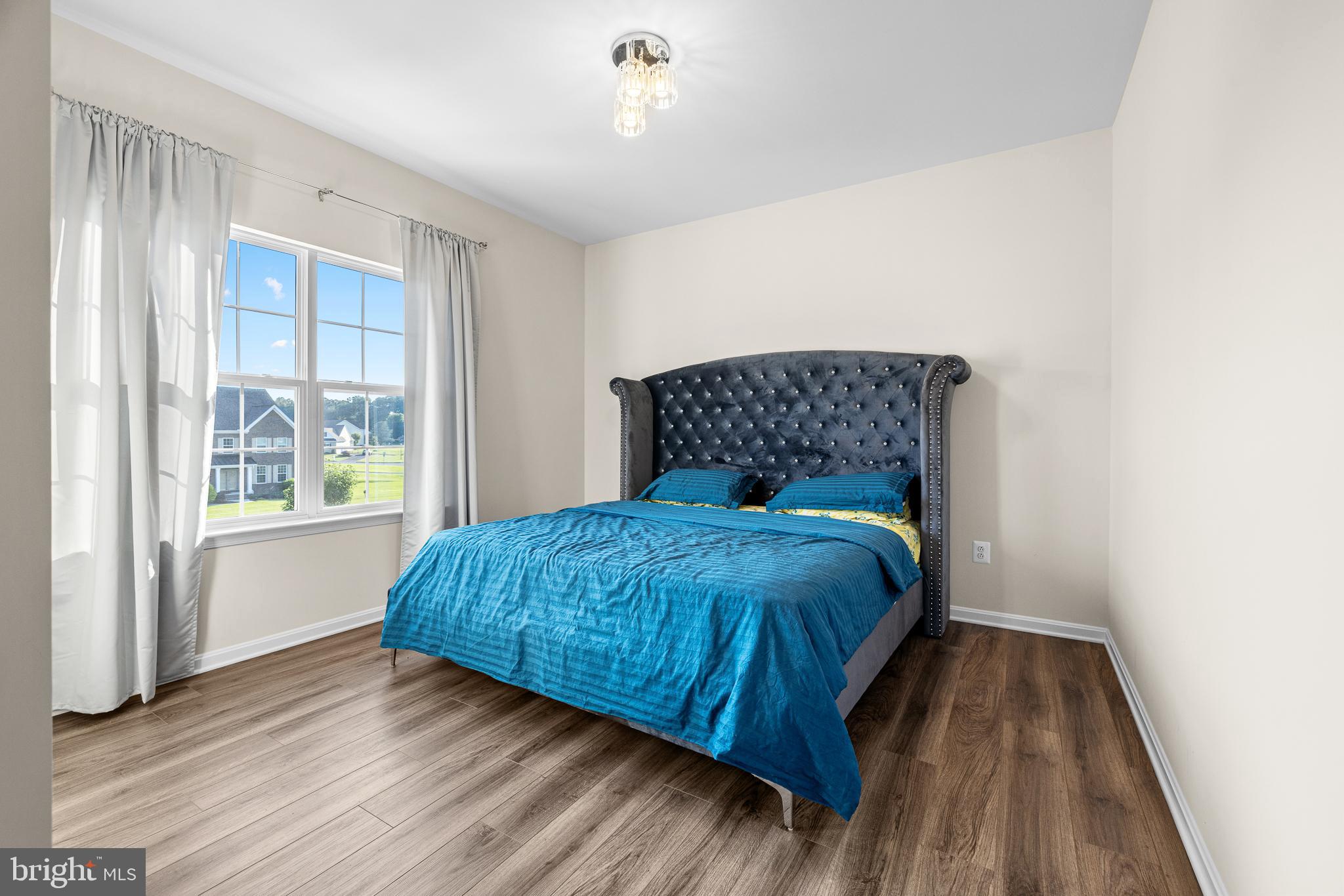 1022 Fawn Haven Walk Dover, DE 19901 - Photo 29 of 46 a bedroom with a bed and wooden floor