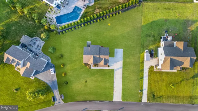 an aerial view of a house with a yard basket ball court and outdoor seating