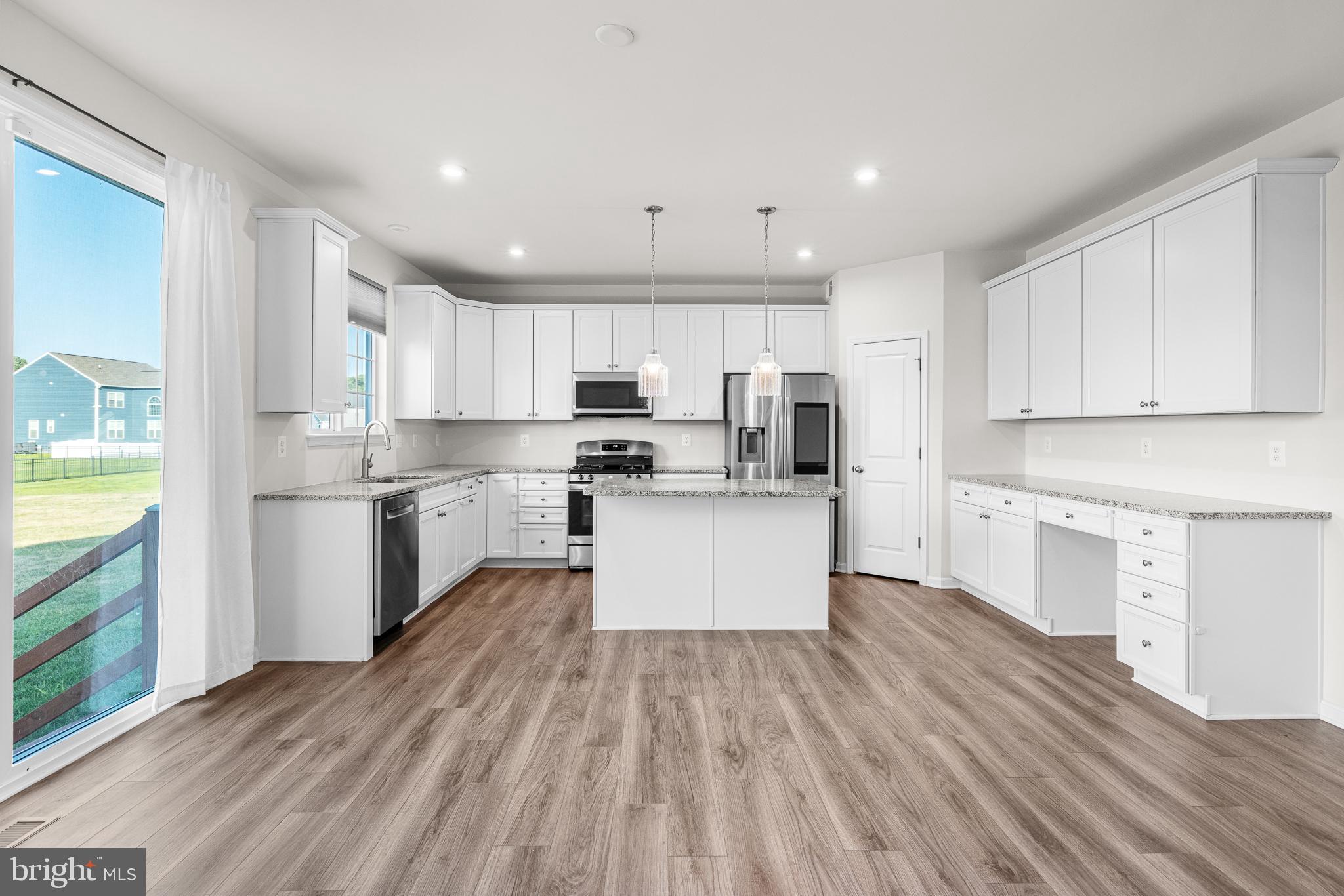 1022 Fawn Haven Walk Dover, DE 19901 - Photo 10 of 46 a kitchen with stainless steel appliances granite countertop a refrigerator a stove top oven a sink dishwasher and white cabinets with wooden floor