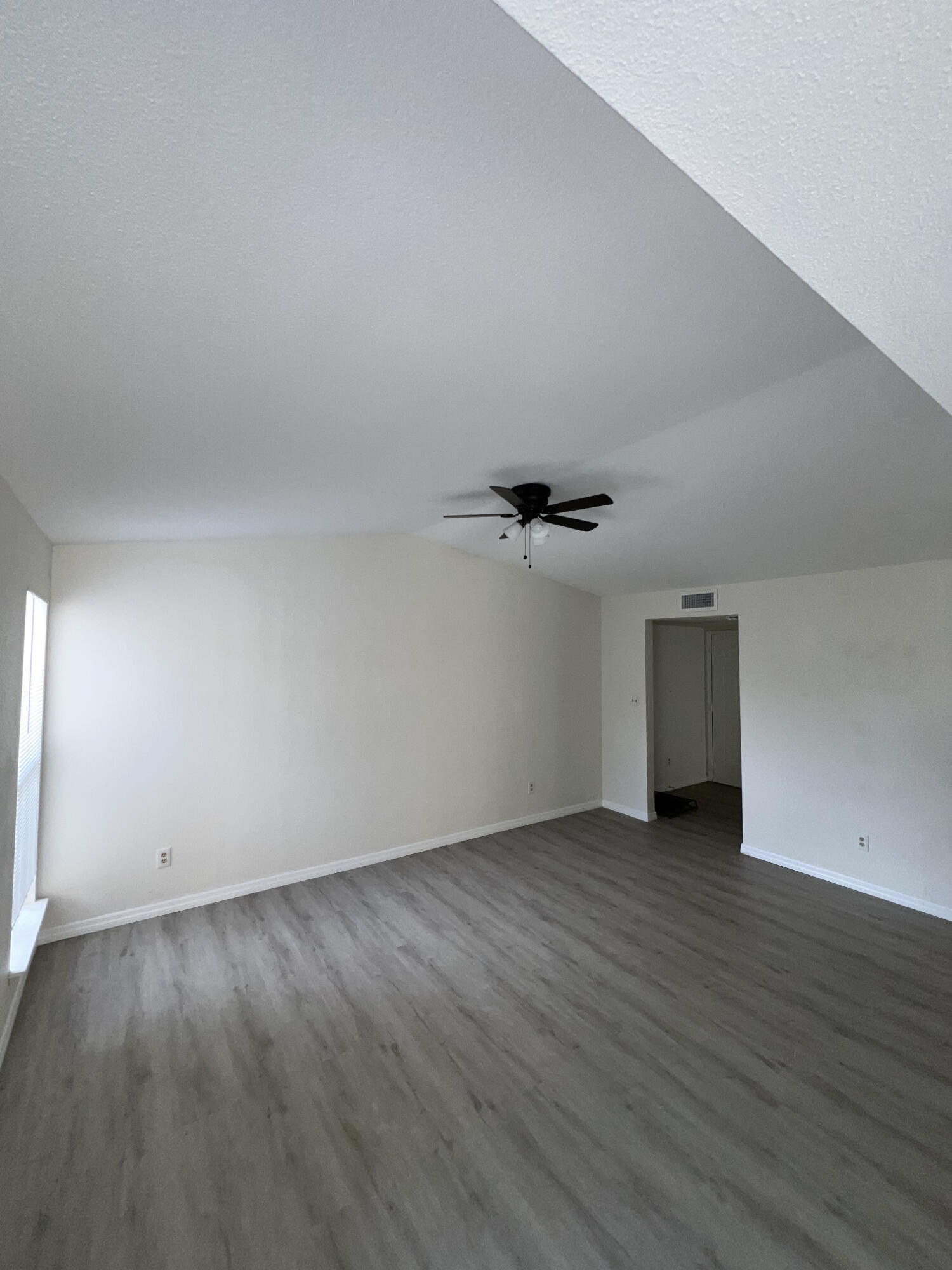 899 Riverside Drive, Unit 620 Coral Springs, FL 33071 - Photo 30 of 46 an empty room with wooden floor and windows