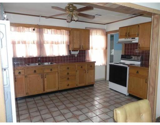 142 Swifts Beach Road Wareham, MA 02571 - Photo 5 of 10 a kitchen with stainless steel appliances kitchen island granite countertop a stove a sink and a microwave