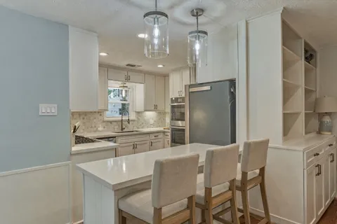 a kitchen with a sink cabinets and stainless steel appliances
