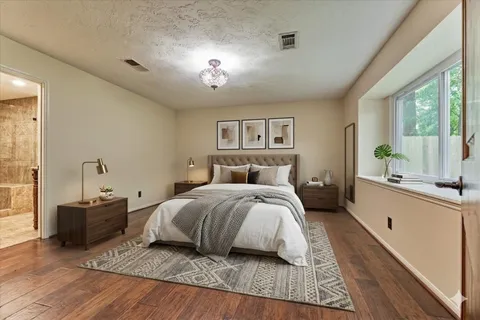 a bedroom with a large bed and a large window