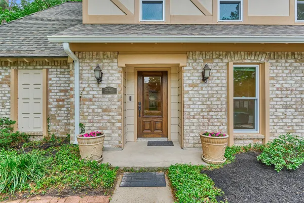 a kitchen with stainless steel appliances kitchen island granite countertop a dining table chairs and cabinets