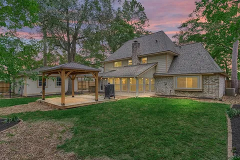 a front view of a house with a yard table and chairs