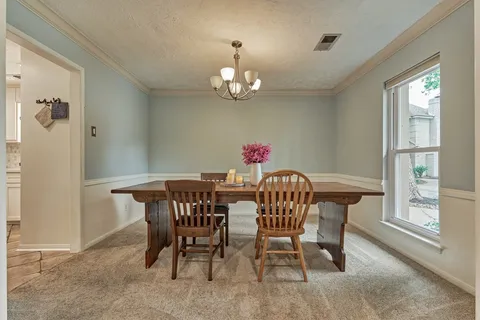 a view of a dining room with furniture window and outside view