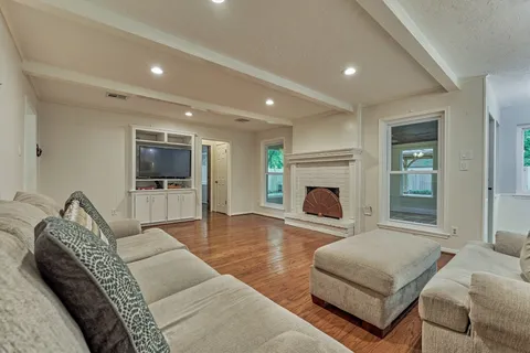 a living room with furniture flat screen tv and a fireplace