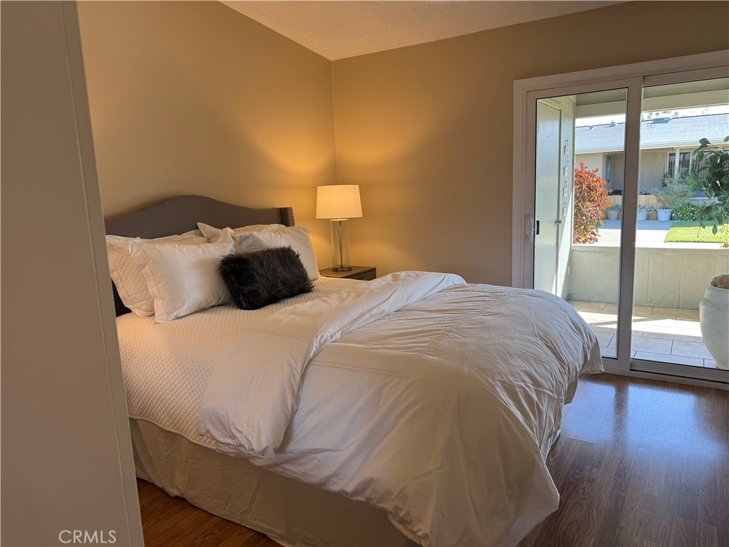 1670 Interlachen Road Seal Beach, CA 90740 - Photo 11 of 23 a bedroom with a bed and wooden floor