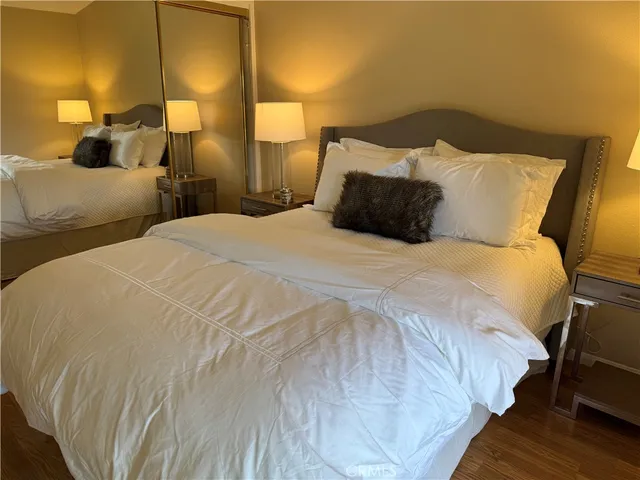a large bed sitting in a bedroom next to a lamp