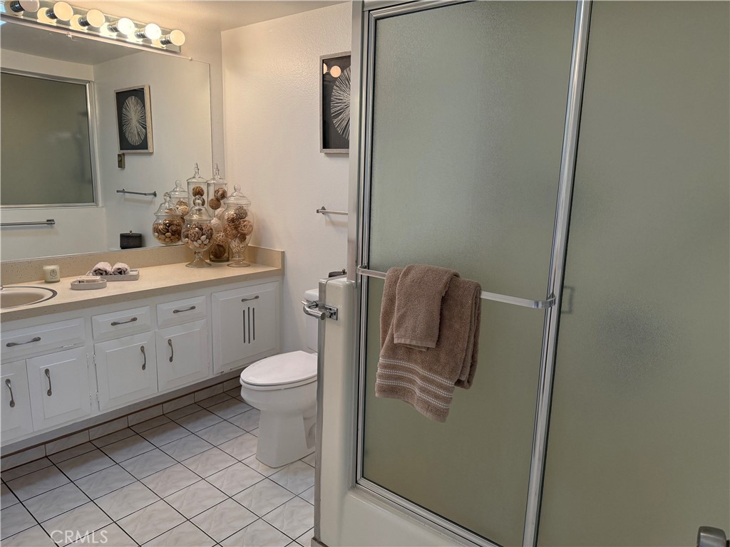 1670 Interlachen Road Seal Beach, CA 90740 - Photo 13 of 23 a bathroom with a toilet sink and mirror