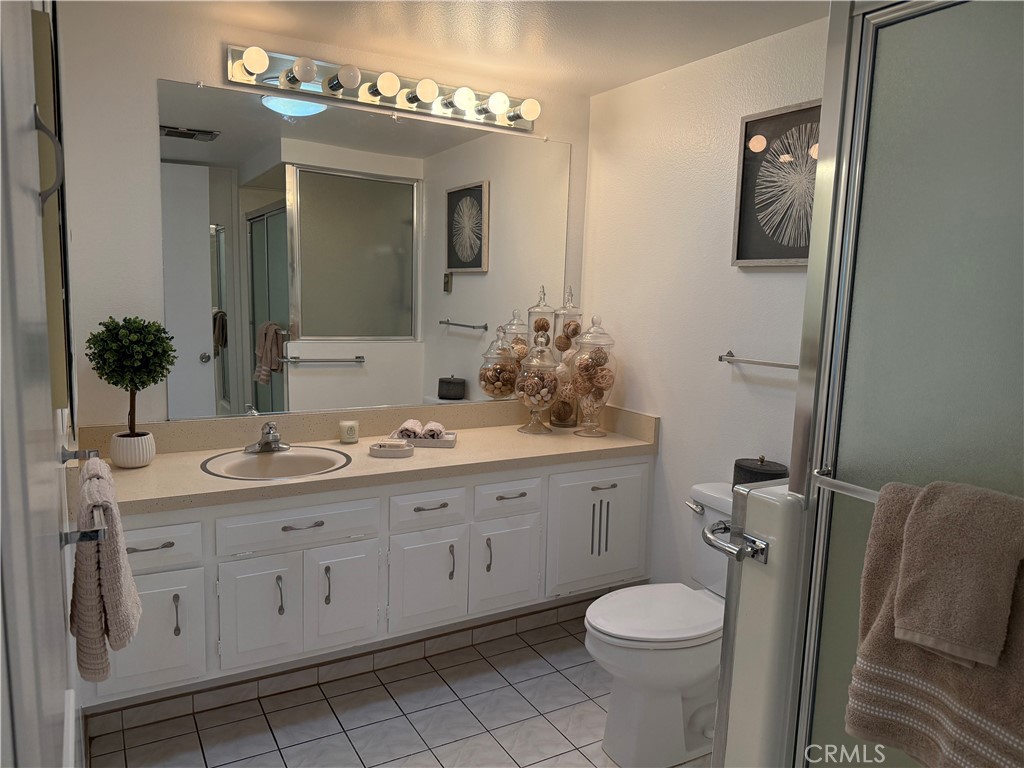 1670 Interlachen Road Seal Beach, CA 90740 - Photo 14 of 23 a bathroom with a toilet sink and mirror