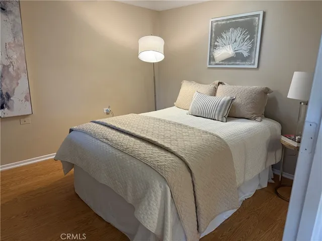 a bedroom with a bed and a painting on the wall