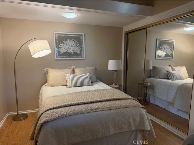 a bedroom with bed and a painting on the wall