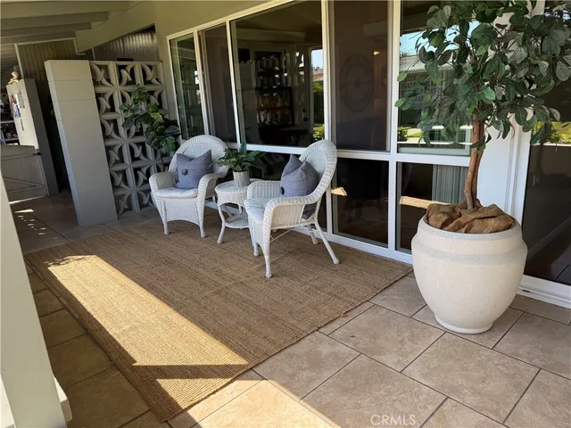 a view of a patio with table and chairs and potted plants