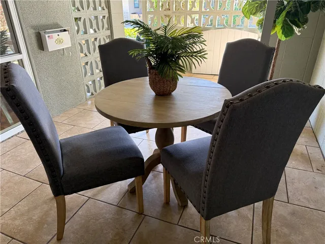 a view of a dining room with furniture and a potted plant