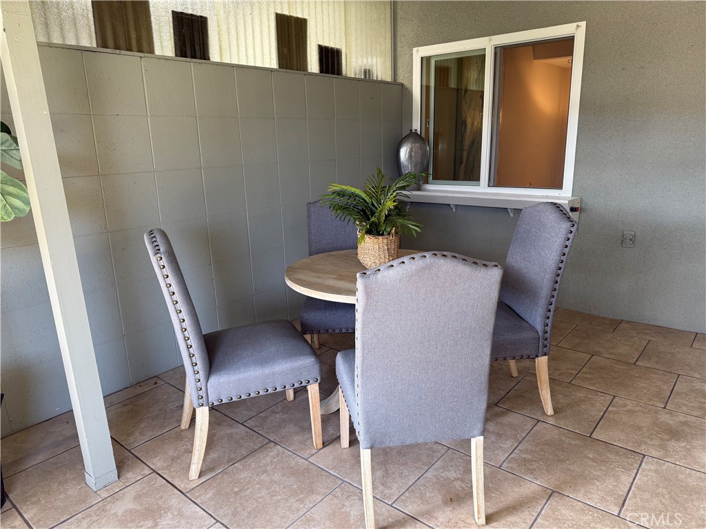 1670 Interlachen Road Seal Beach, CA 90740 - Photo 22 of 23 a view of a dining room with furniture and a potted plant