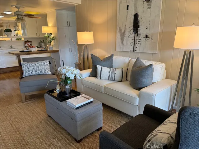 a living room with furniture and a potted plant on table