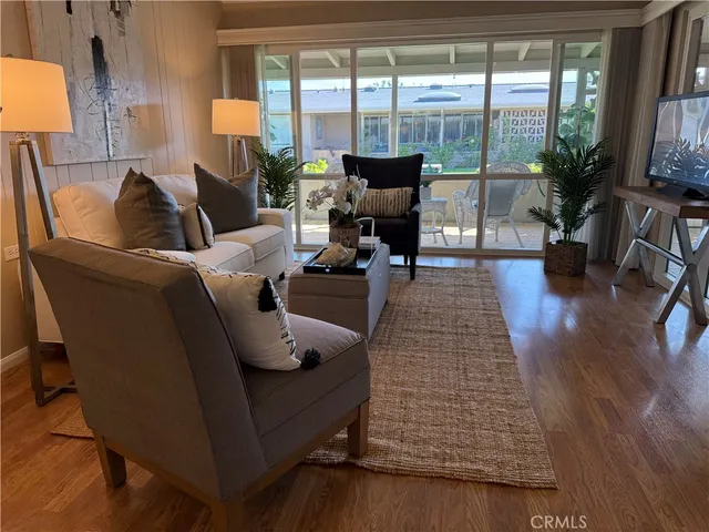a living room with furniture and floor to ceiling window