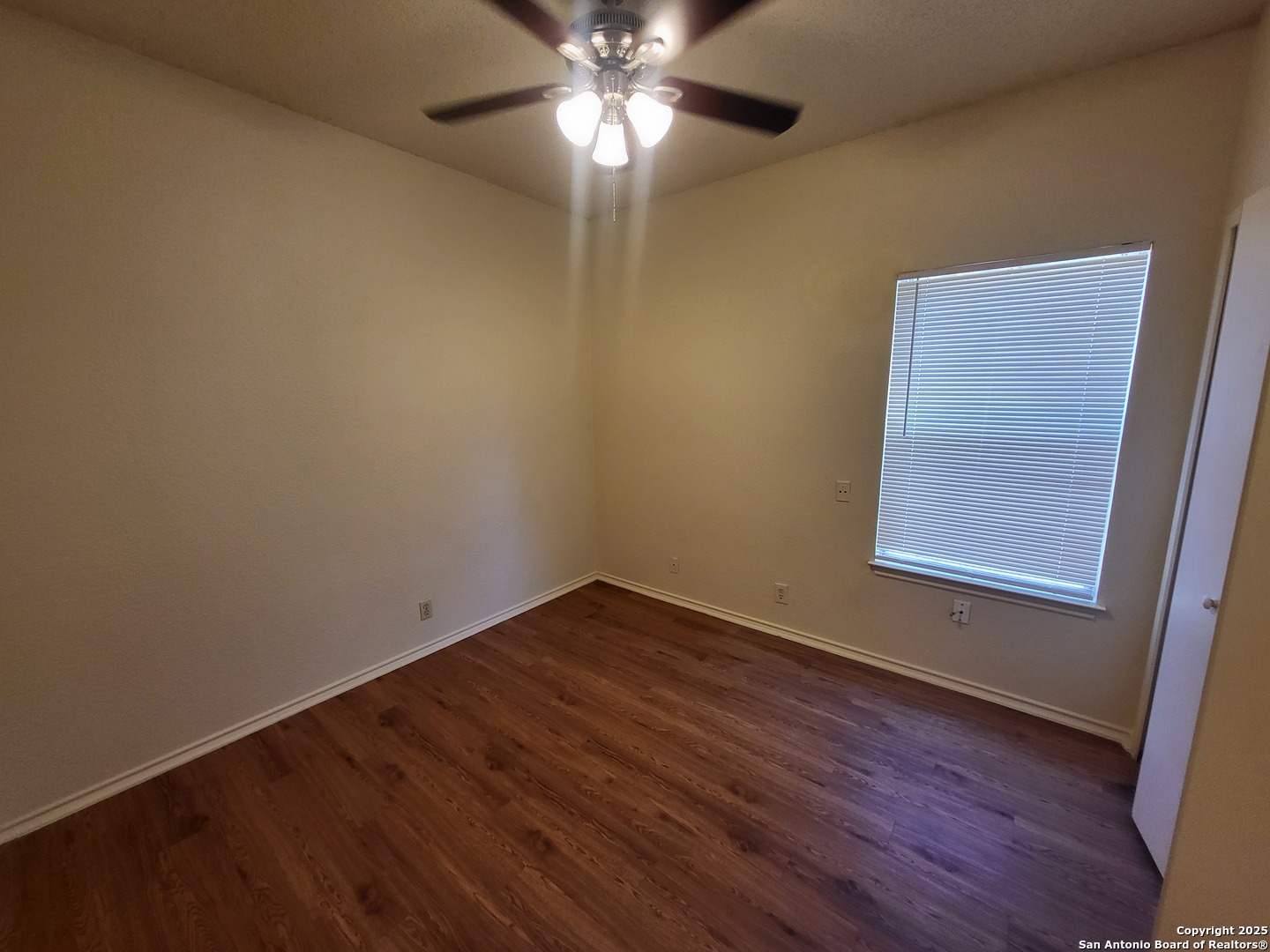 3405 Ridge Smoke San Antonio, TX 78247 - Photo 12 of 16 a view of an empty room with wooden floor and a window