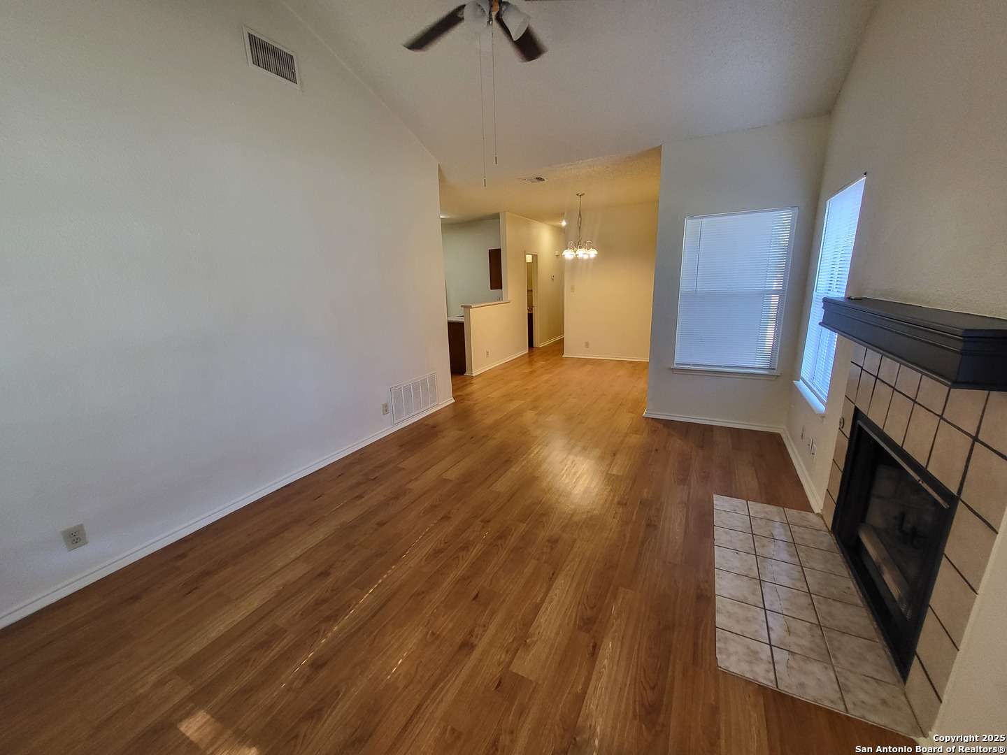 3405 Ridge Smoke San Antonio, TX 78247 - Photo 4 of 16 wooden floor in an empty room with a fireplace
