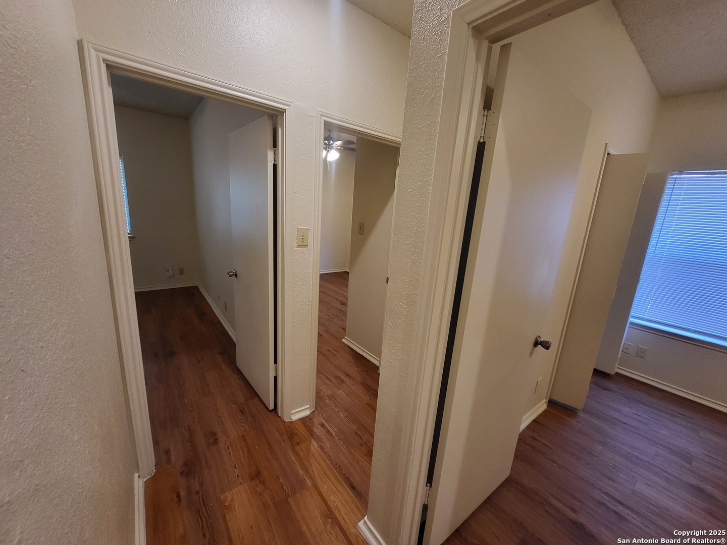 3405 Ridge Smoke San Antonio, TX 78247 - Photo 10 of 16 a view of a hallway with wooden floor and staircase