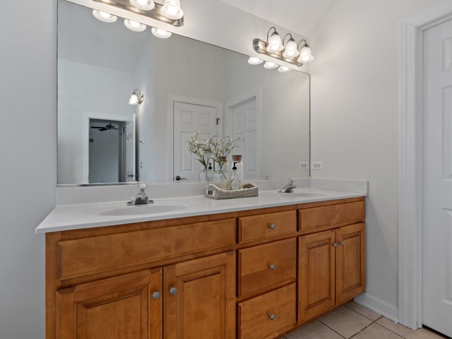 3035 Rollingridge Road Naperville, IL 60564 - Photo 17 of 28 a bathroom with a sink vanity and a mirror