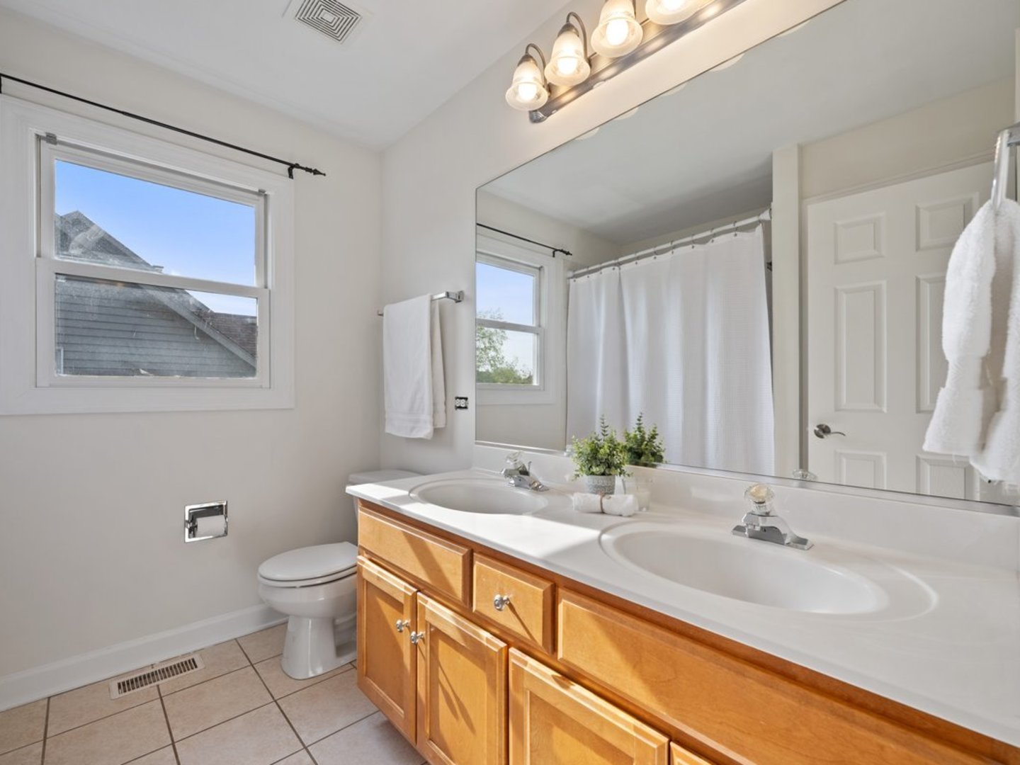 3035 Rollingridge Road Naperville, IL 60564 - Photo 19 of 28 a bathroom with a double vanity sink mirror and toilet