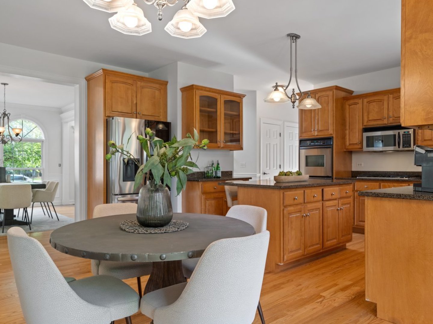3035 Rollingridge Road Naperville, IL 60564 - Photo 6 of 28 a dining room with furniture a chandelier a large window and appliances