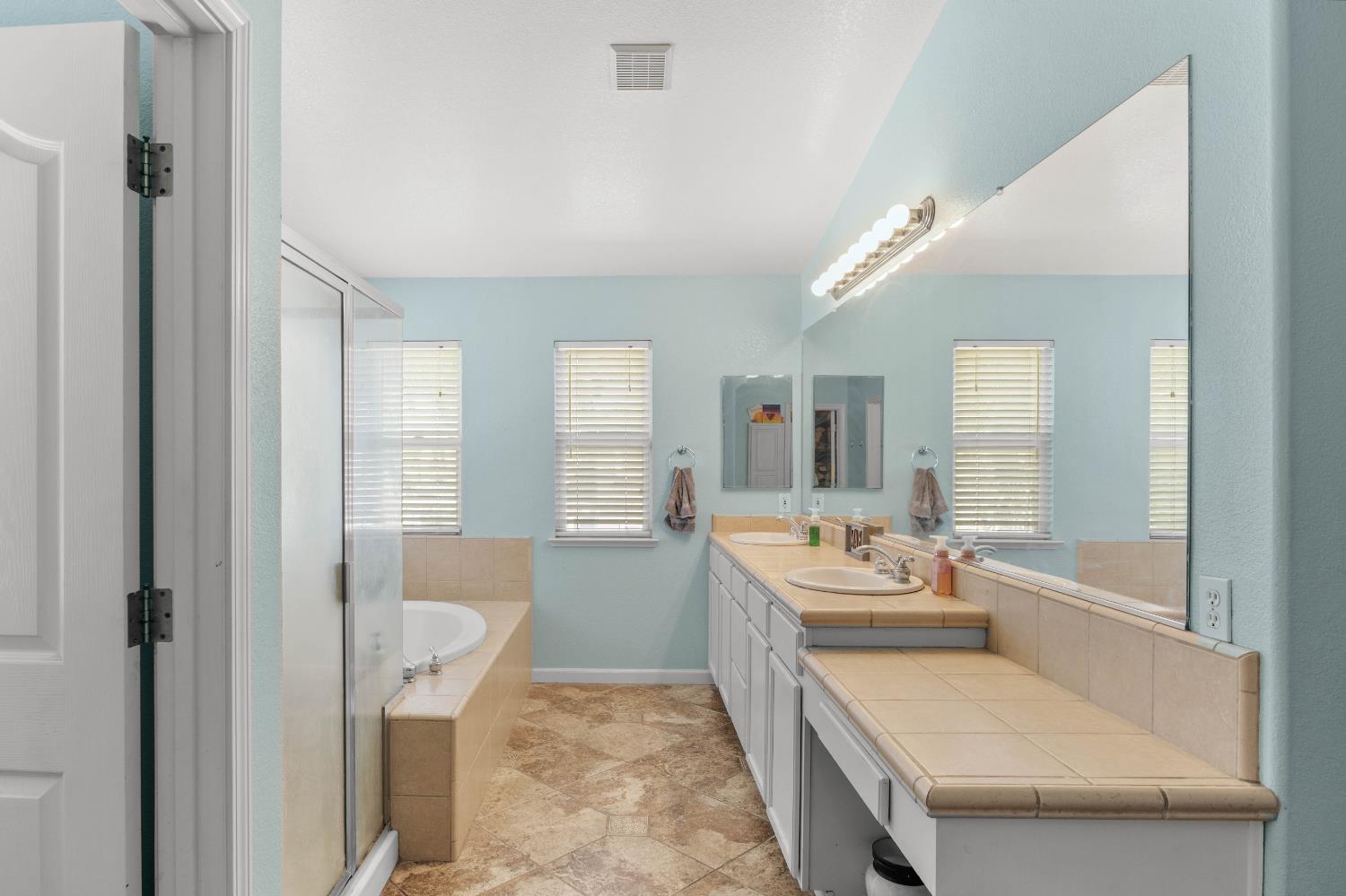 1777 Daniel Drive Ripon, CA 95366 - Photo 25 of 44 Primary bath, double sinks and vanity, tub, shower stall
