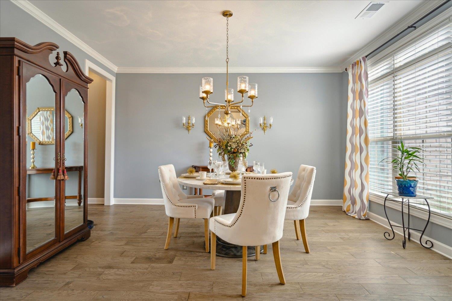 10460 Riley River Road Lakeland, TN 38002 - Photo 6 of 39 Dining area with ornamental molding, light hardwood / wood-style flooring, and an inviting chandelier