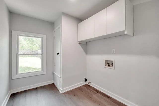 a view of a room with rack on the wall and a window
