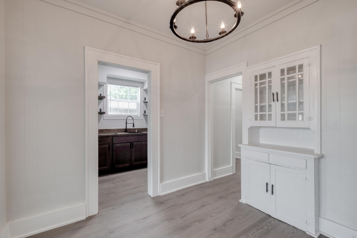 7406 Bethune Avenue Austin, TX 78752 - Photo 2 of 38 an empty room with wooden floor cabinet and windows