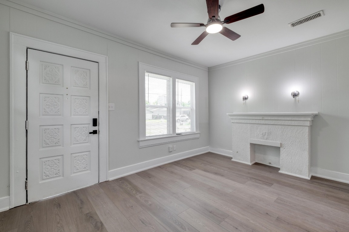 7406 Bethune Avenue Austin, TX 78752 - Photo 21 of 38 a view of an empty room with a fireplace and a window