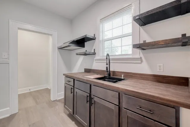 a kitchen with stainless steel appliances granite countertop a sink and a window