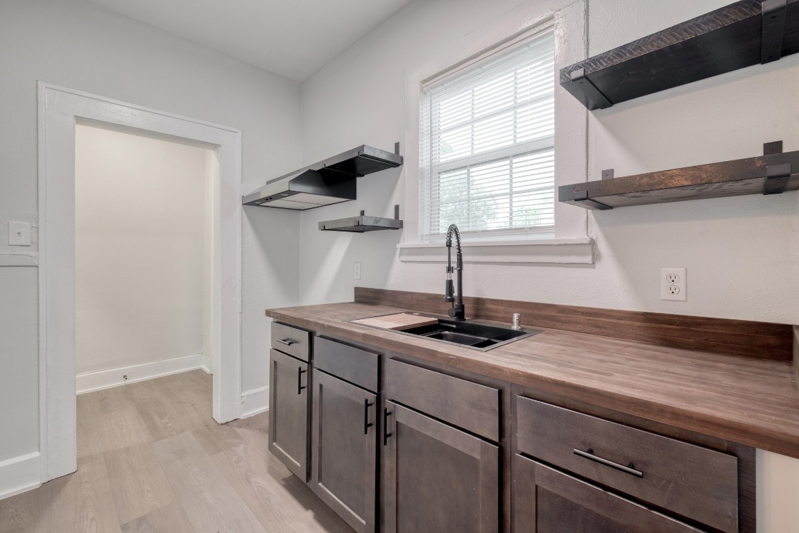 7406 Bethune Avenue Austin, TX 78752 - Photo 25 of 38 a kitchen with stainless steel appliances granite countertop a sink and a window