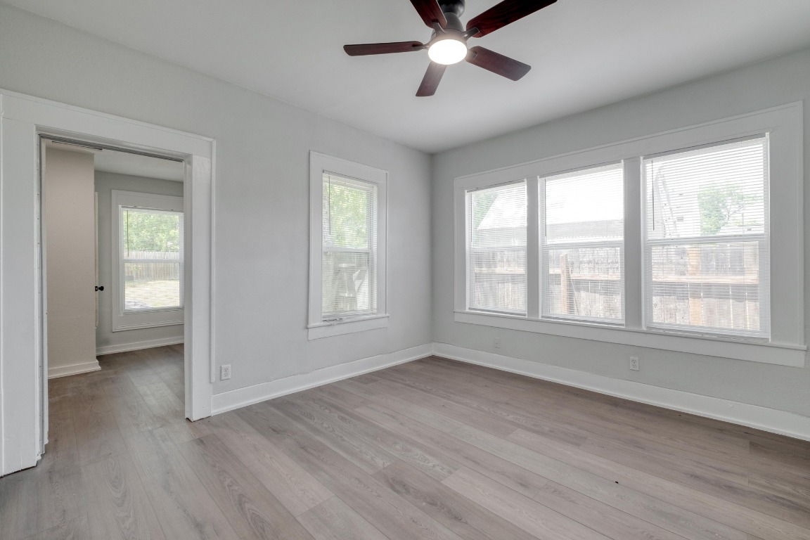 7406 Bethune Avenue Austin, TX 78752 - Photo 29 of 38 a view of an empty room with wooden floor and a window