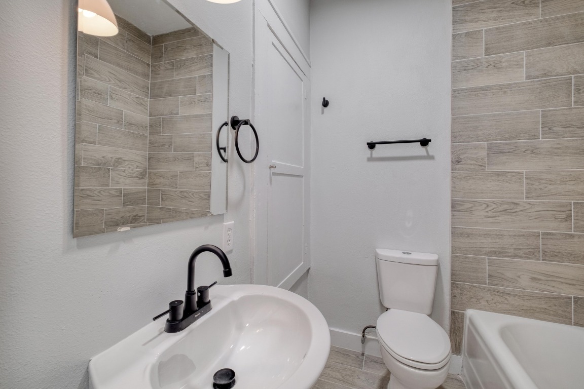 7406 Bethune Avenue Austin, TX 78752 - Photo 30 of 38 a bathroom with a toilet a sink and mirror