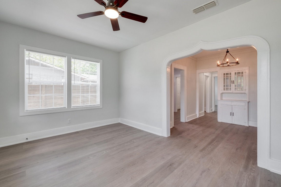 7406 Bethune Avenue Austin, TX 78752 - Photo 3 of 38 wooden floor in an empty room with a window