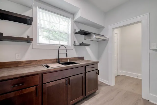 a kitchen with a sink cabinets and window