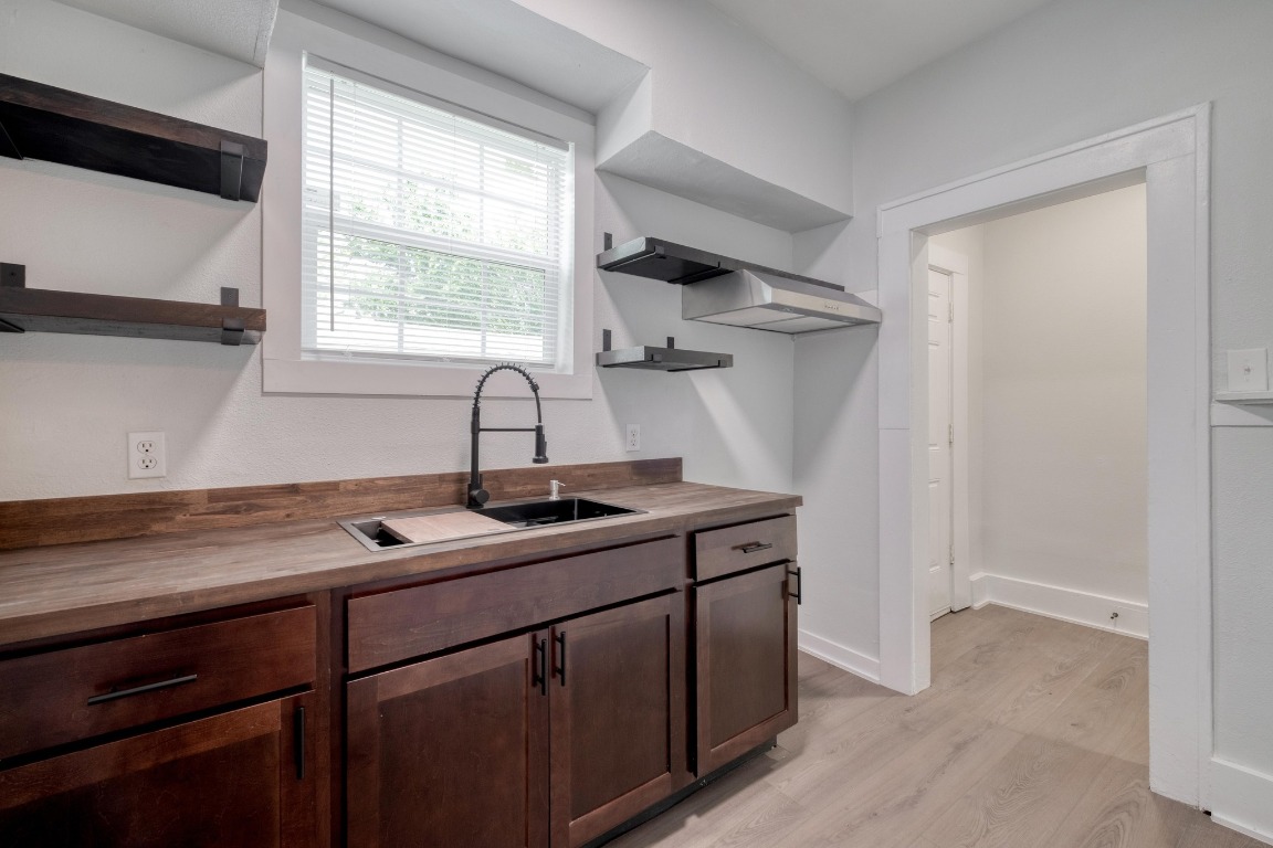 7406 Bethune Avenue Austin, TX 78752 - Photo 5 of 38 a kitchen with a sink cabinets and window