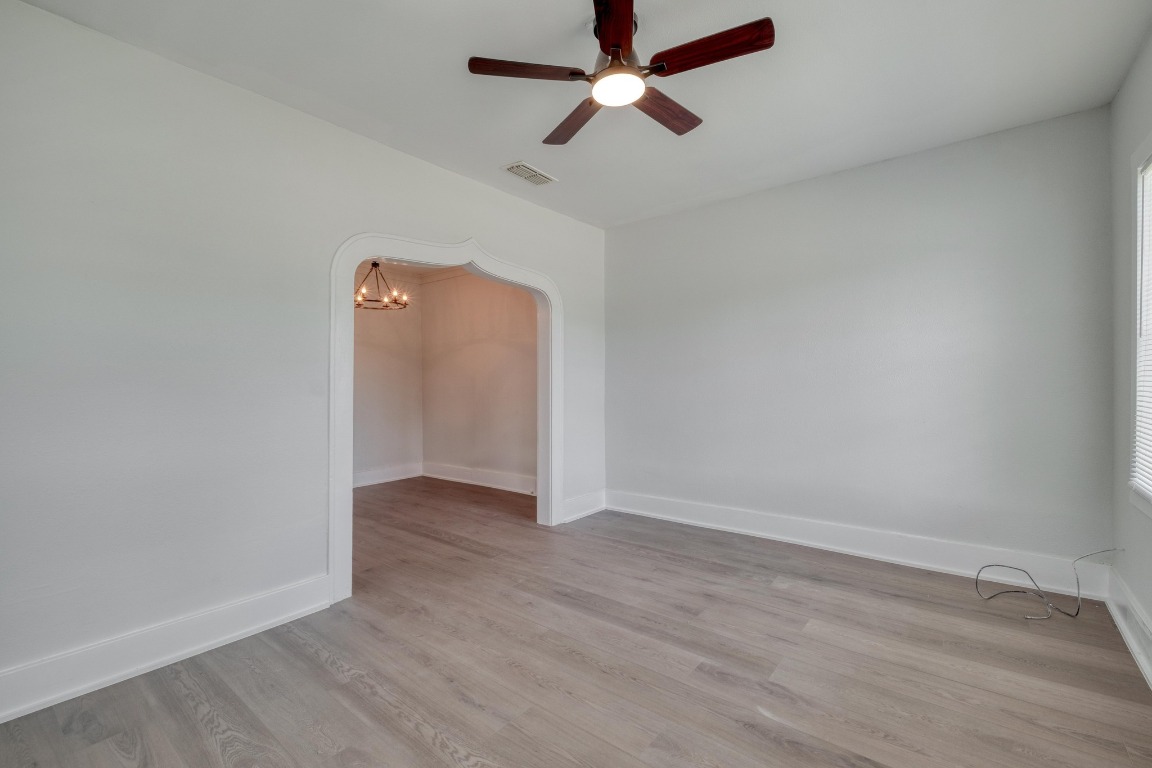 7406 Bethune Avenue Austin, TX 78752 - Photo 7 of 38 an empty room with wooden floor and windows