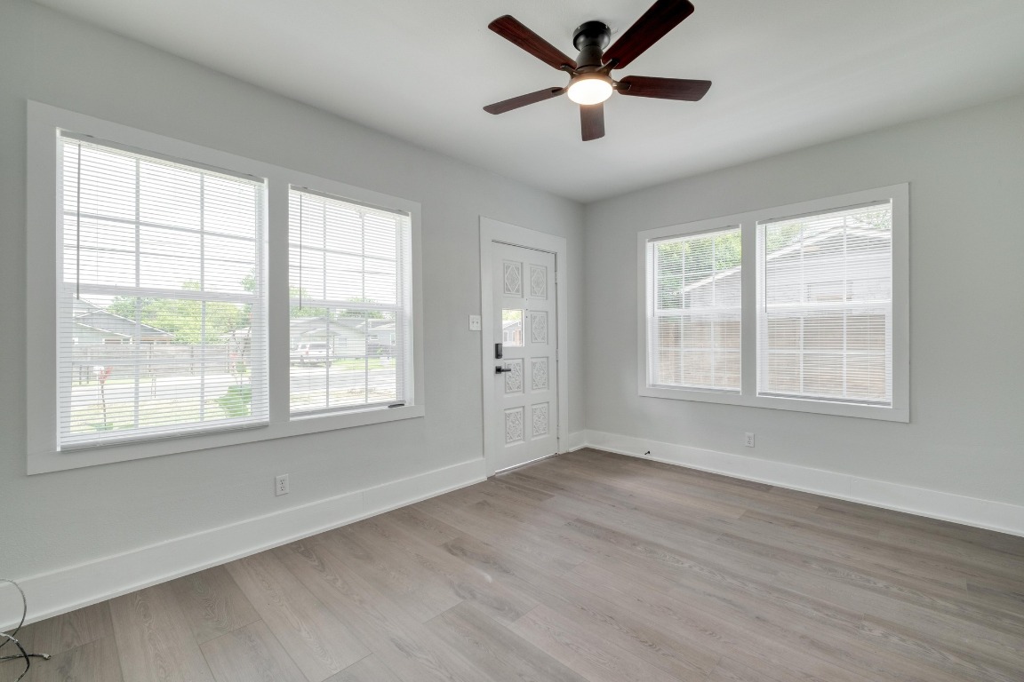 7406 Bethune Avenue Austin, TX 78752 - Photo 8 of 38 a view of an empty room with a window and wooden floor