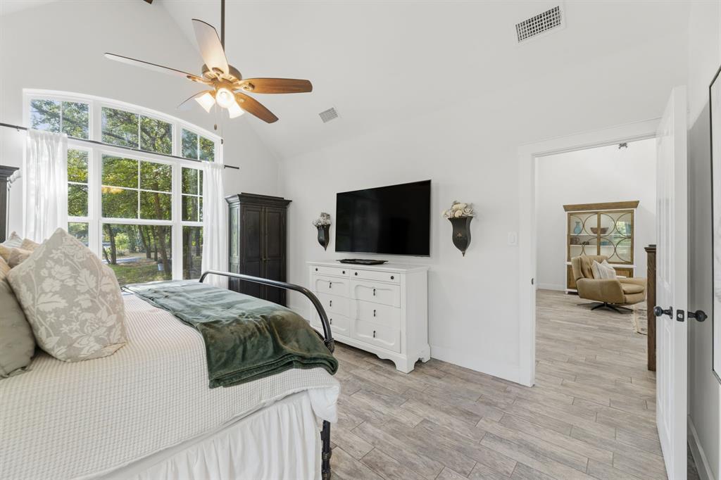 665 Chinn Chapel Road Copper Canyon, TX 75077 - Photo 18 of 26 a spacious bedroom with a bed and a flat screen tv