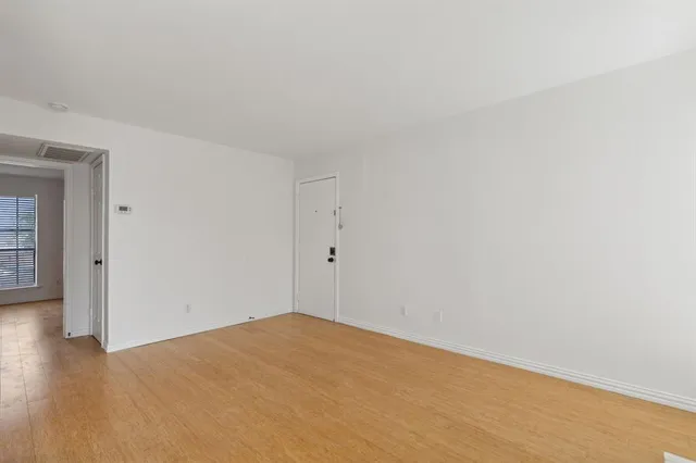 an empty room with windows and closet