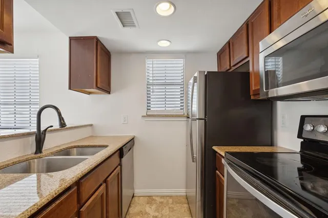 a kitchen with a sink and a stove