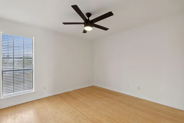 a bathroom with a granite countertop sink toilet mirror and bathtub