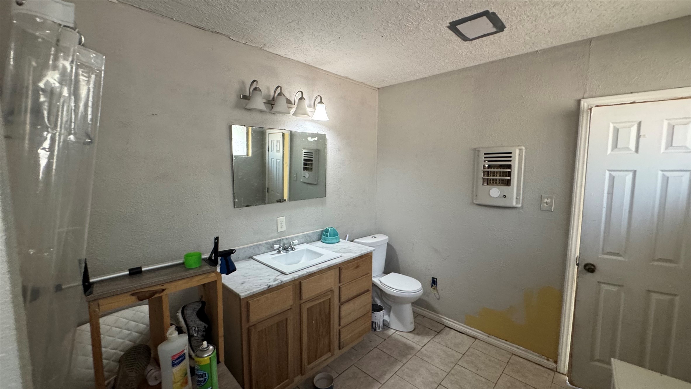 4717 17th Street Bacliff, TX 77518 - Photo 15 of 16 a bathroom with a toilet sink and mirror