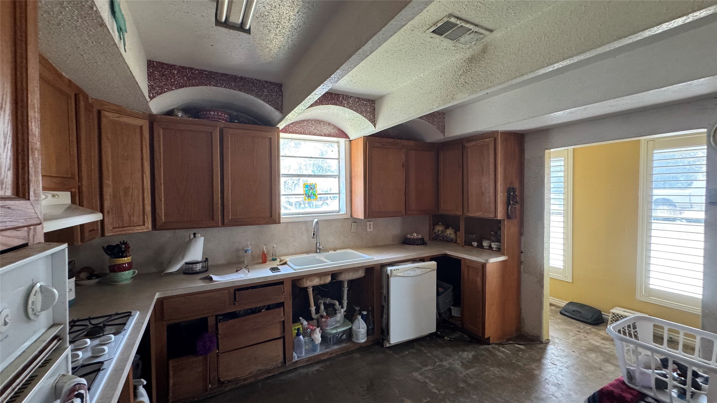 4717 17th Street Bacliff, TX 77518 - Photo 8 of 16 a kitchen with a sink appliances cabinets and a window