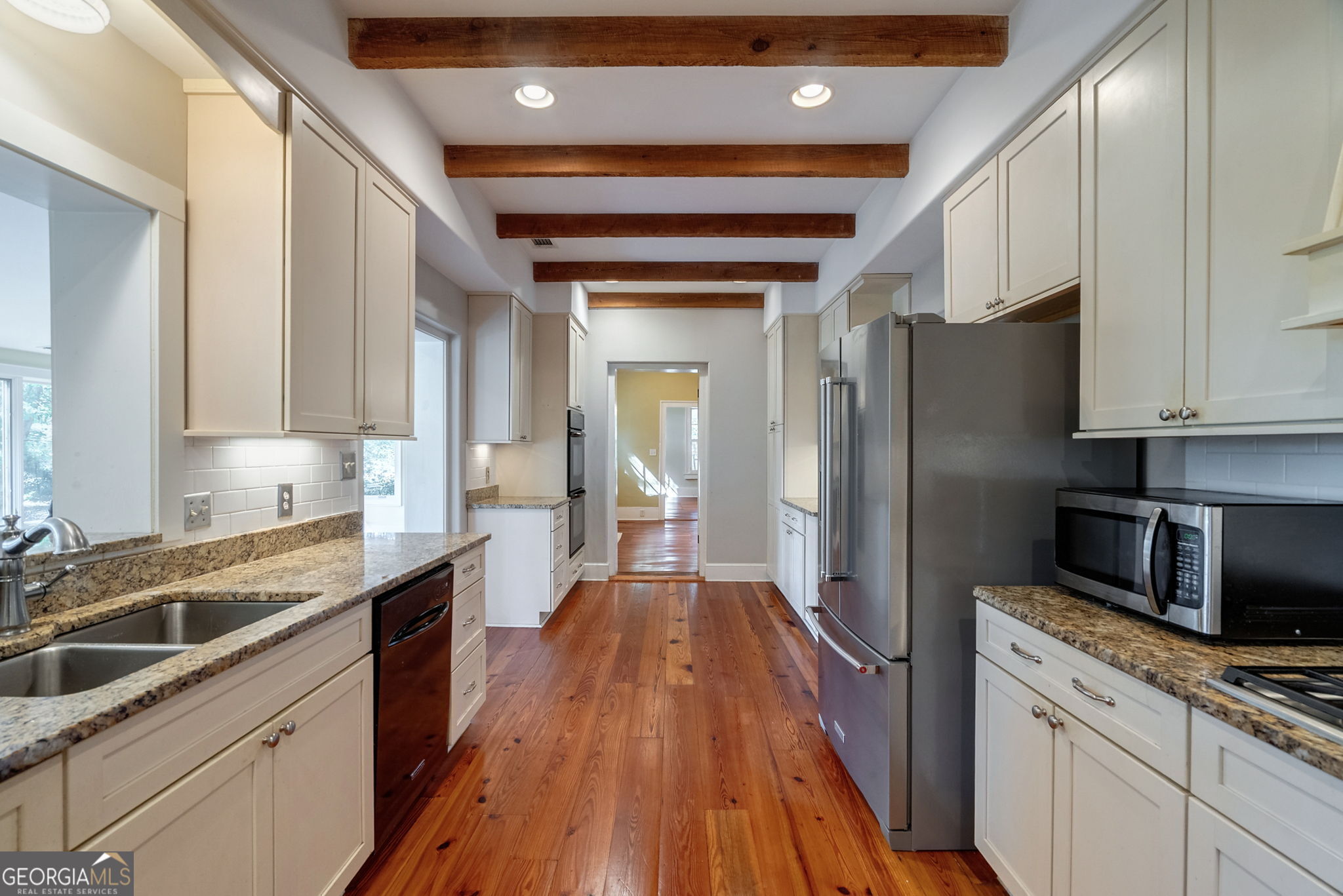 1761 Farmington Road Madison, GA 30650 - Photo 11 of 61 a kitchen with stainless steel appliances a refrigerator sink and microwave
